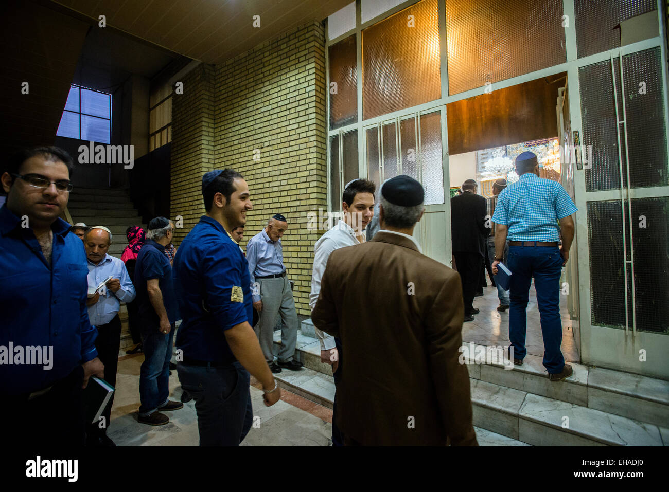 Jews come in praying hall of Yusef Abad Synagogue, one of the biggest in Northern Tehran, and
