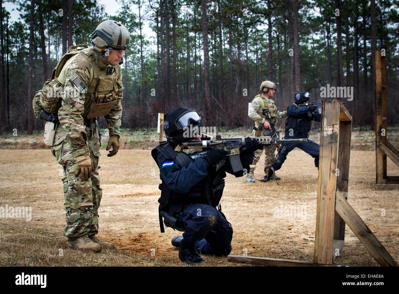 A US Army Green Beret soldier special forces advises Honduran TIGRES soldiers as they clear a compound during training February 24, 2015 at Eglin Air Force Base, Florida. Stock Photo