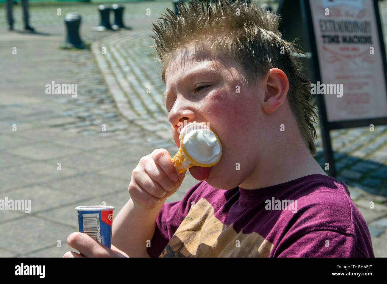 young boy eating and Ice cream on a hot summer day in Bristol Stock Photo