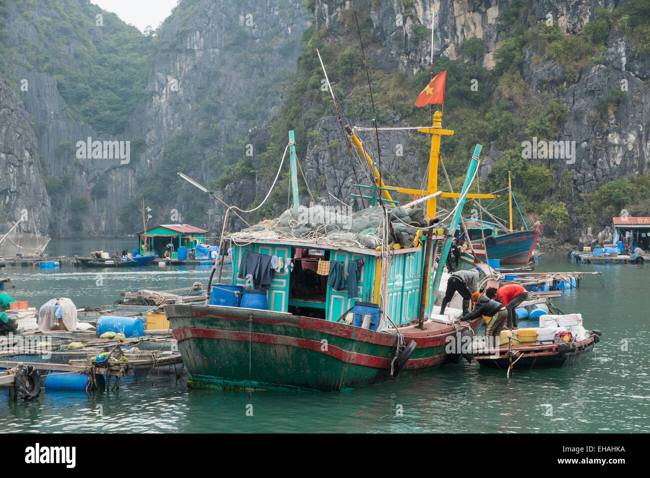 Fishing boat amongst limestone karst in Cat Ba National Park,Ha long,Halong Bay, Vietnam Stock Photo