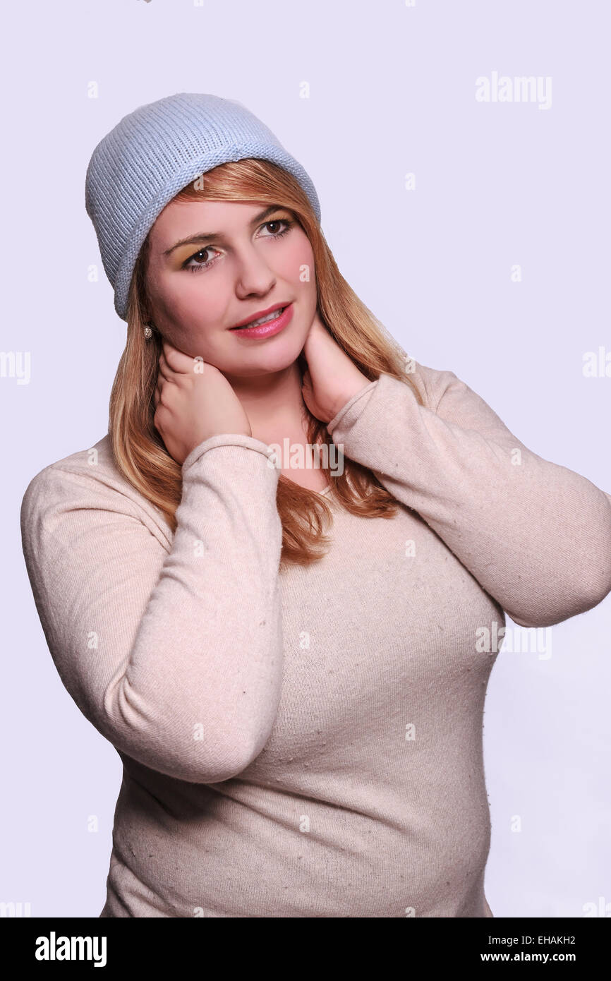 Portrait of a chubby young blond woman with hat Stock Photo - Alamy