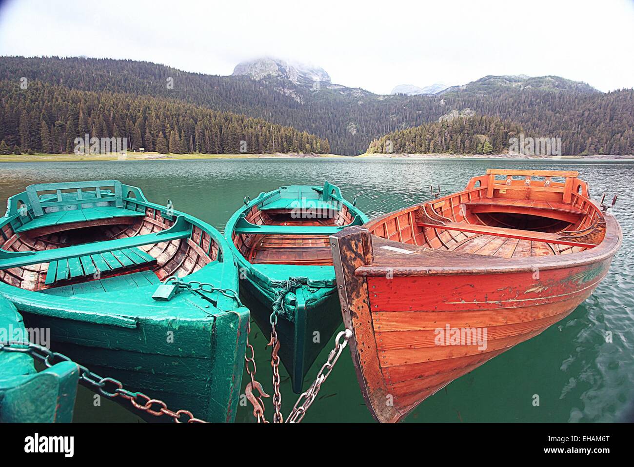 wooden boat on a mountain lake landscape mountain sky Stock Photo - Alamy