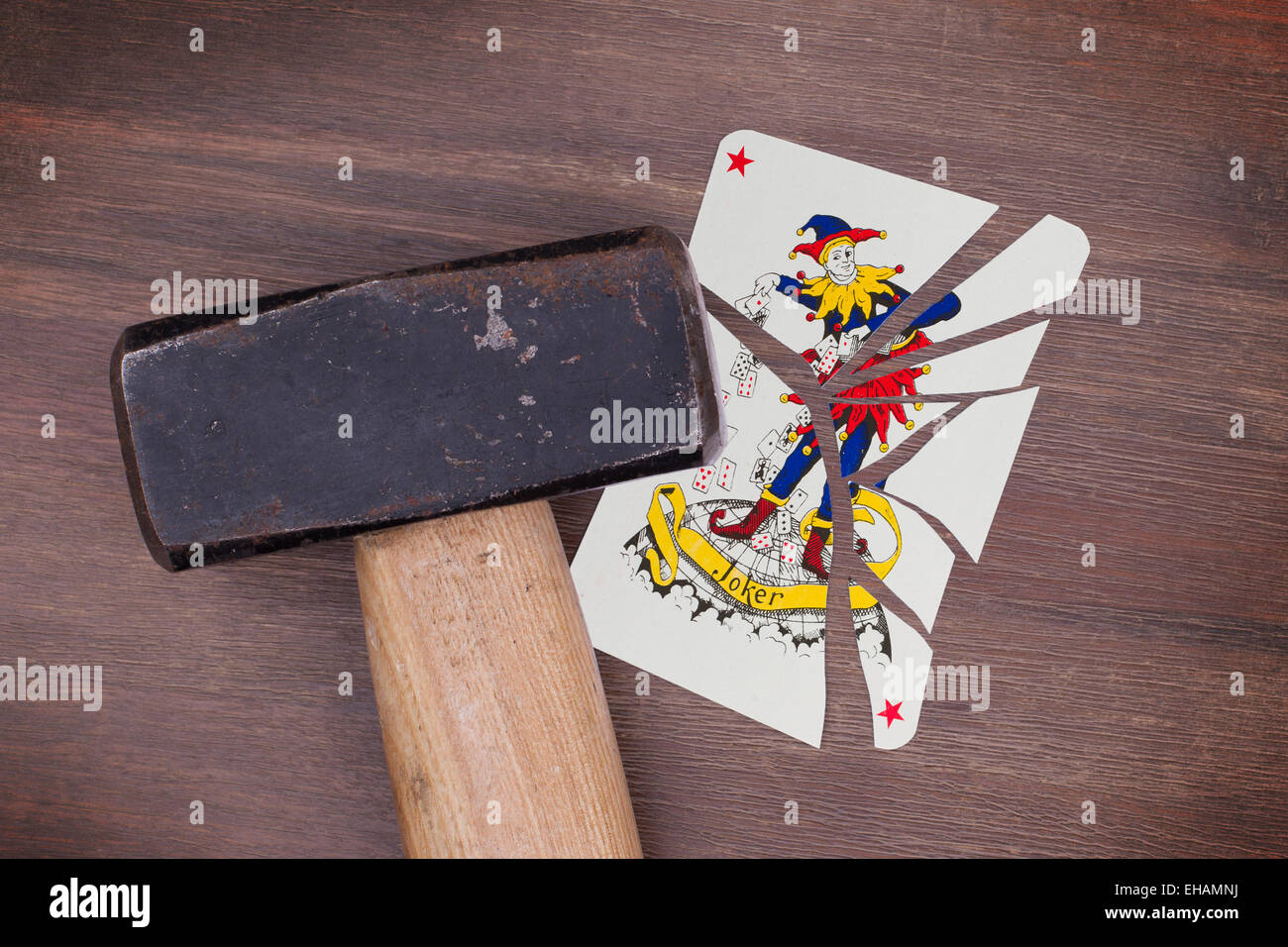 Hammer with a broken card, vintage look, joker Stock Photo Alamy