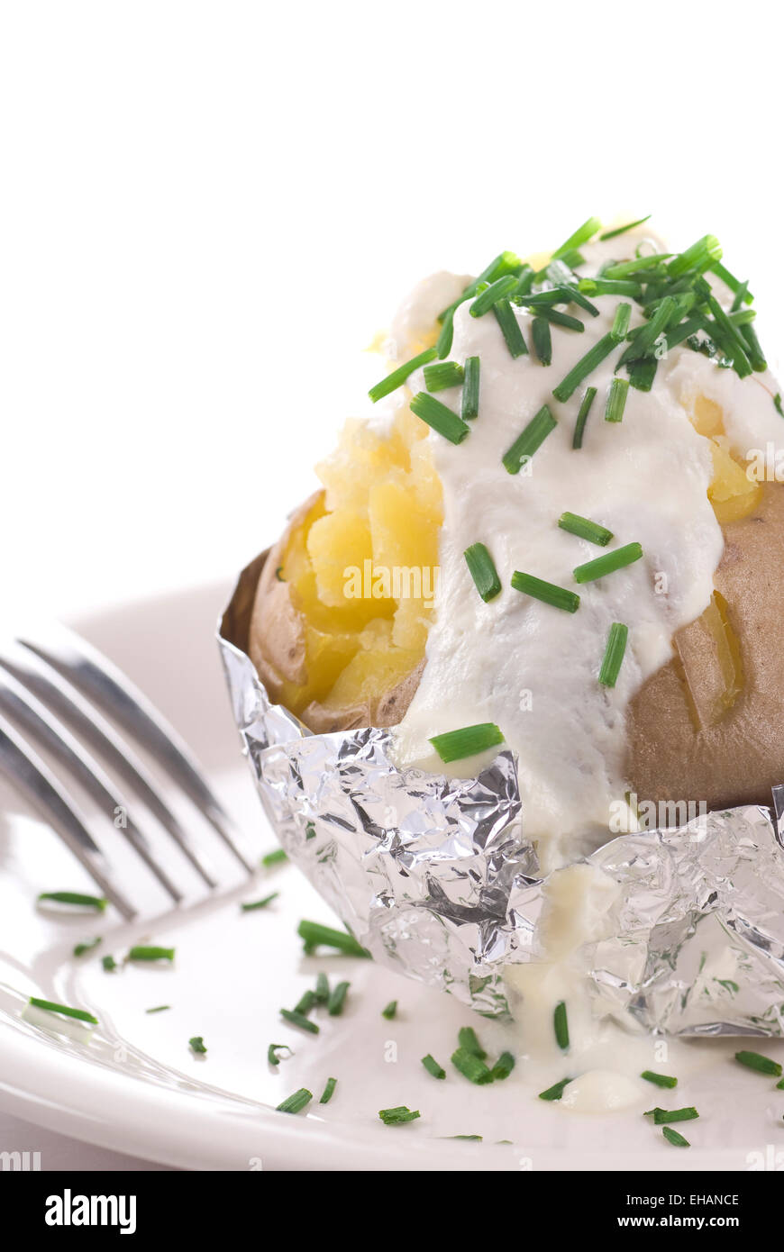 Baked potato with sour cream and chive Stock Photo