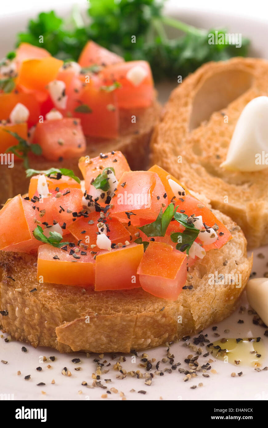 Bruschetta with tomato, olive oil, parsley, pepper and garlic. Stock Photo