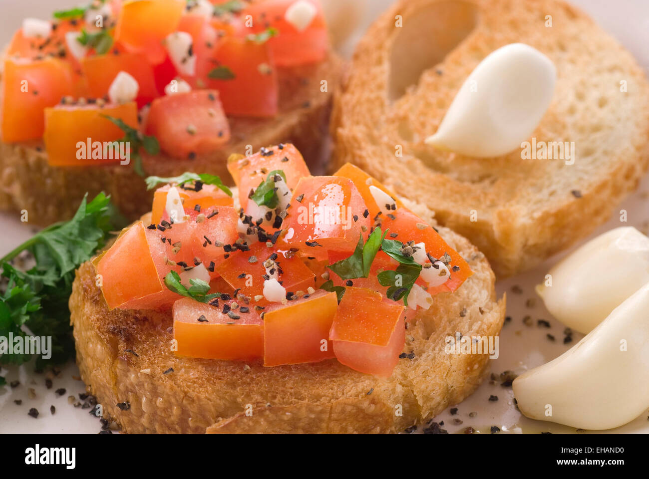 Bruschetta with tomato, olive oil, parsley, pepper and garlic. Stock Photo