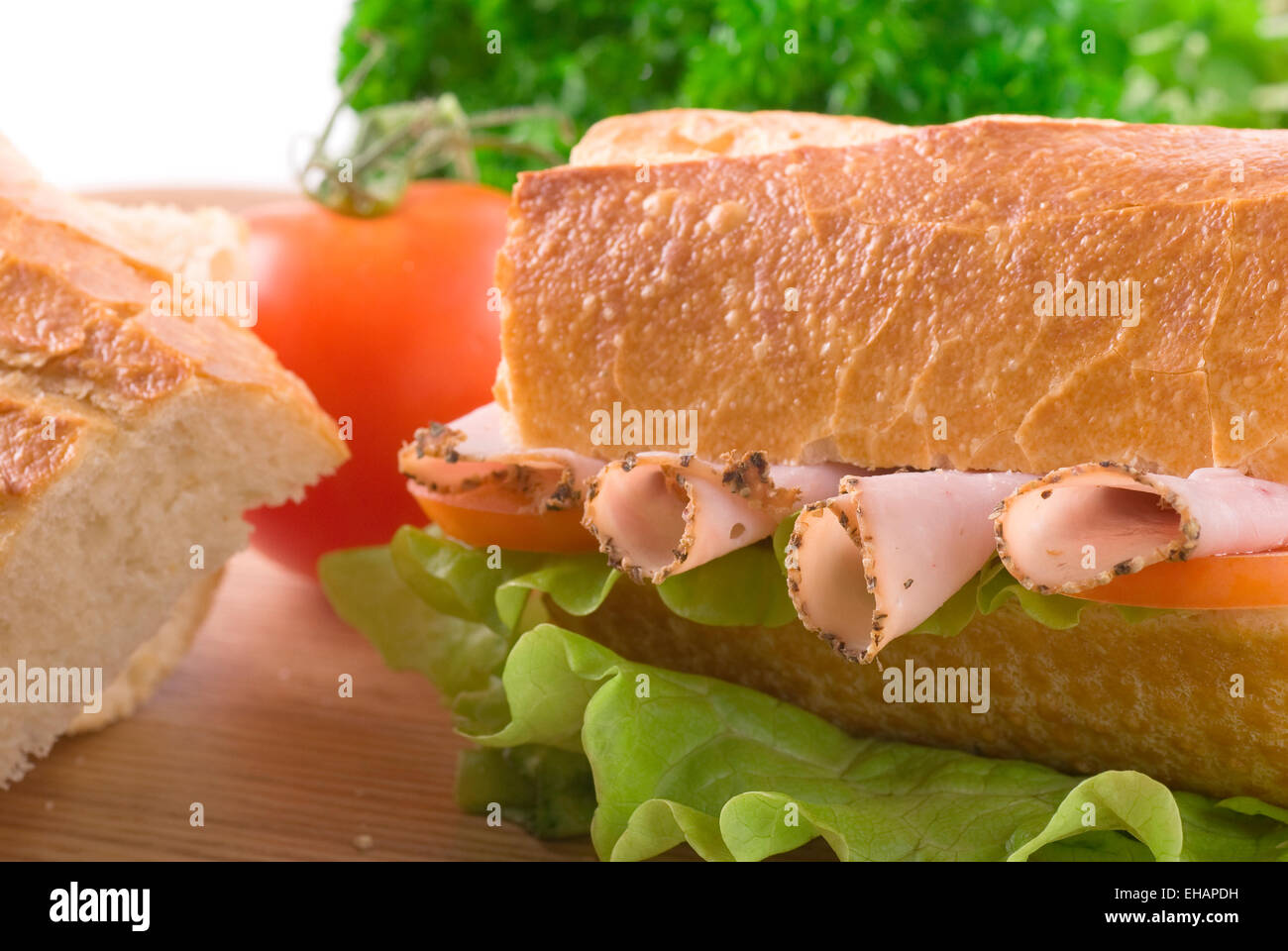 Baguette with pastrami/ham, lettuce and tomato Stock Photo Alamy