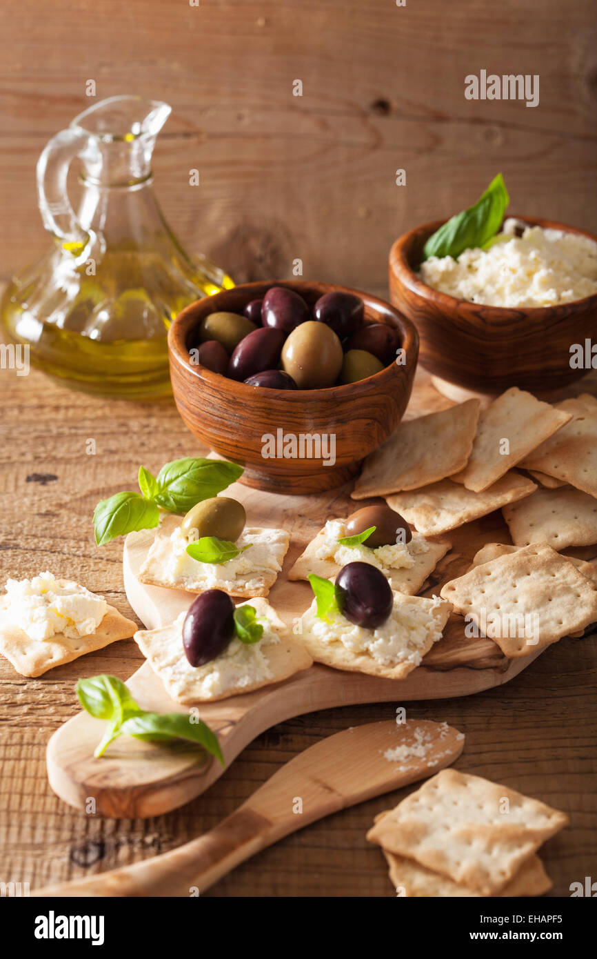 crackers with soft cheese and olives. healthy appetizer Stock Photo