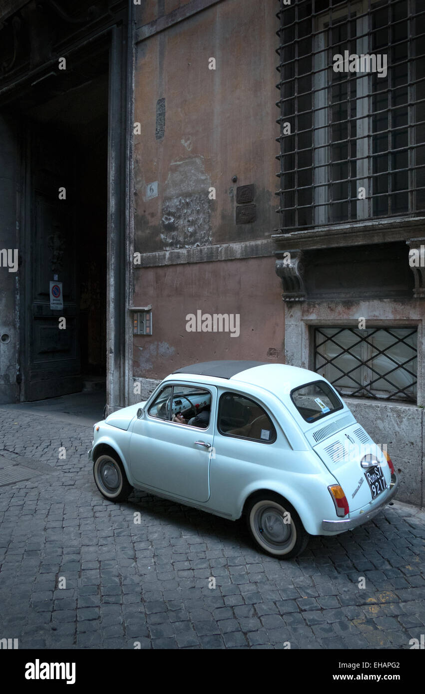 Old car, vintage Fiat Cinquecento parked in the street. Rome, Roma, Italy, Italia, Italian city Stock Photo
