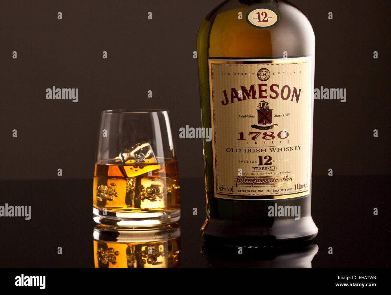 Jameson Whiskey bottle and glass with ice cubes Stock Photo