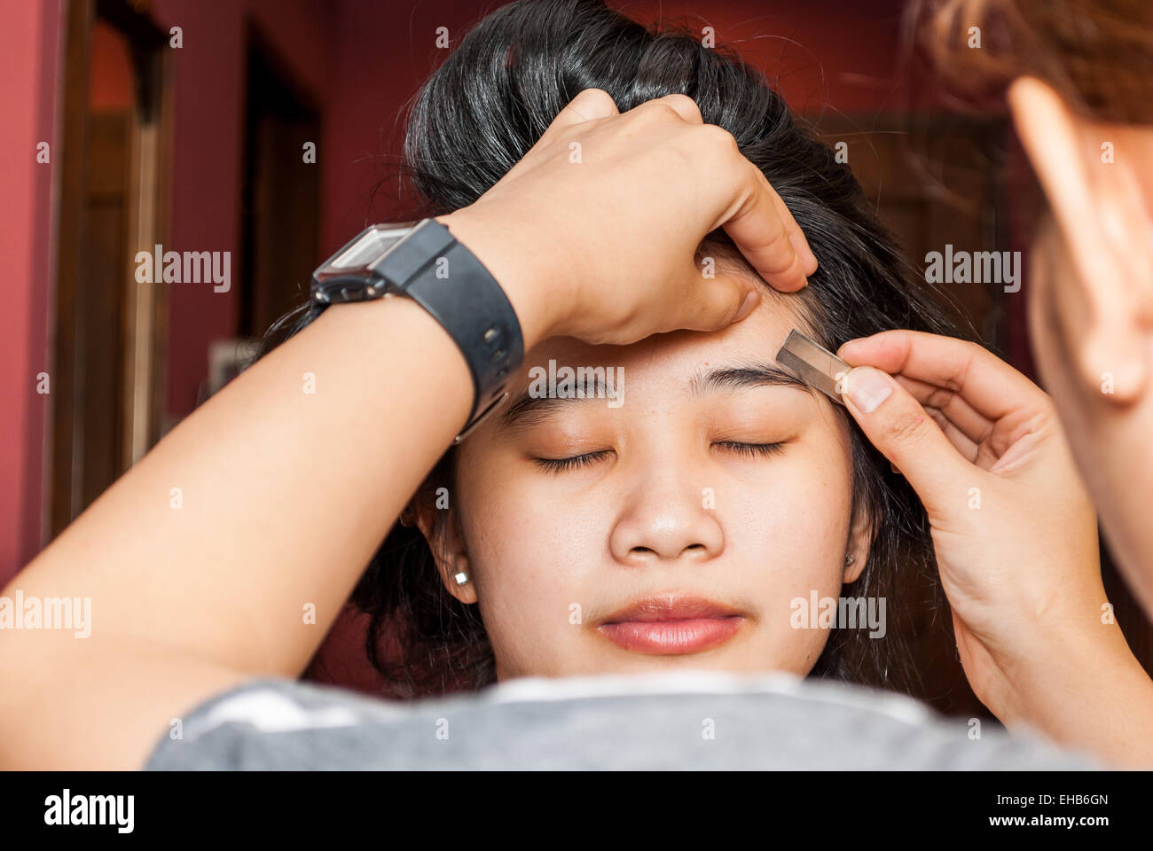 Asian Thai Girl Getting Eyebrow Shaped. Stock Photo