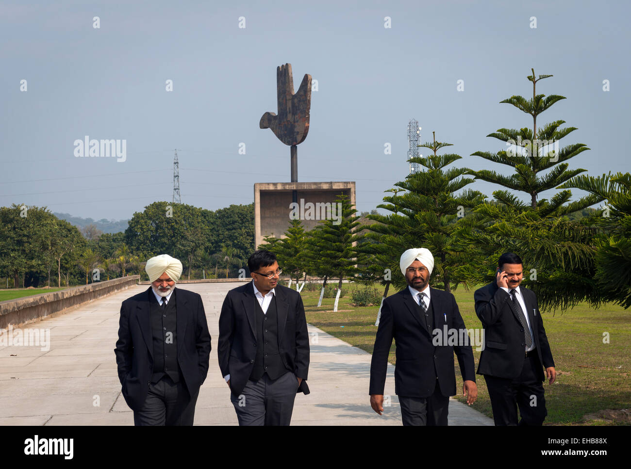 Indian barristers or lawyers near Le Corbusier's open hand symbol near the High Court in Chandigarh, India. Stock Photo