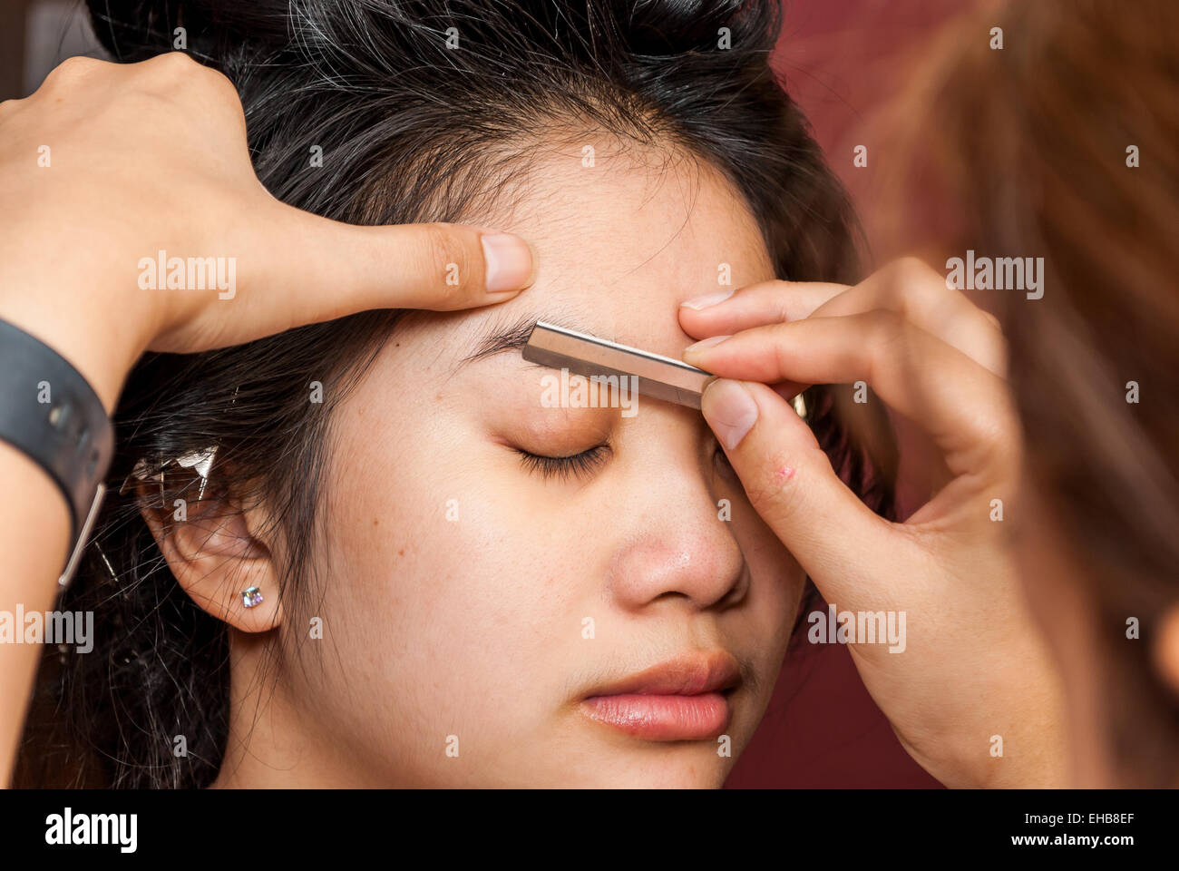 Asian Thai Girl Getting Eyebrow Shaped. Stock Photo