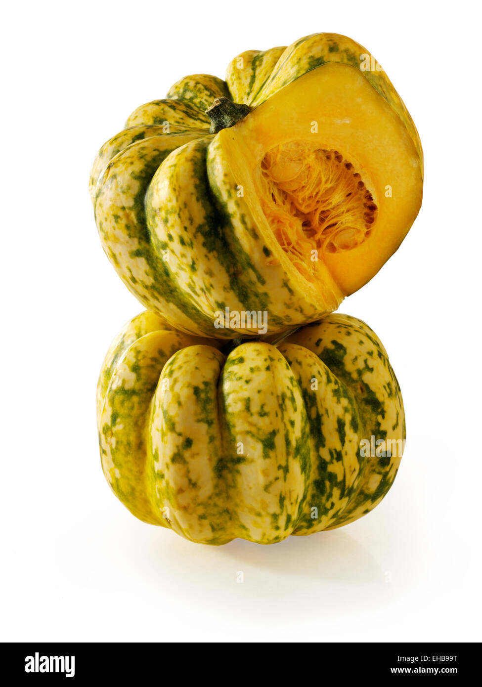 Fresh whole and cut Harlequin Squash against a white background Stock Photo