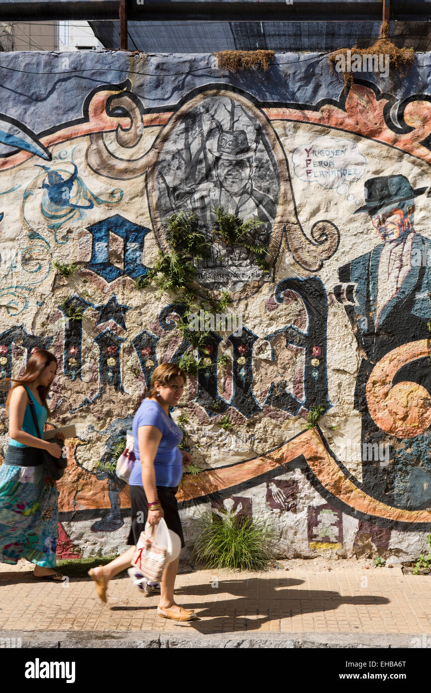 Argentina, Buenos Aires, San Telmo, San Lorenzo, women walking past street graffiti Stock Photo