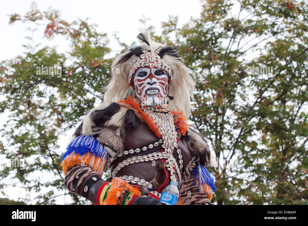 Afro Caribbean man in a wild wig and face paint at Hackney carnival