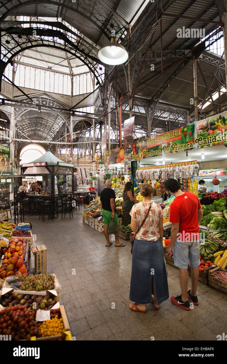 Argentina, Buenos Aires, San Telmo indoor produce market, shoppers at fruit and vegetable stall Stock Photo