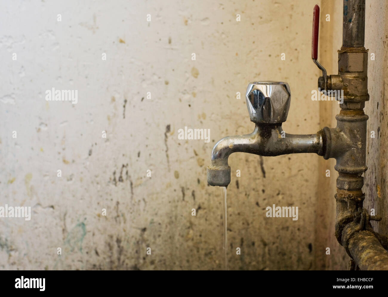 old and dirty faucet with pipes and water Stock Photo Alamy
