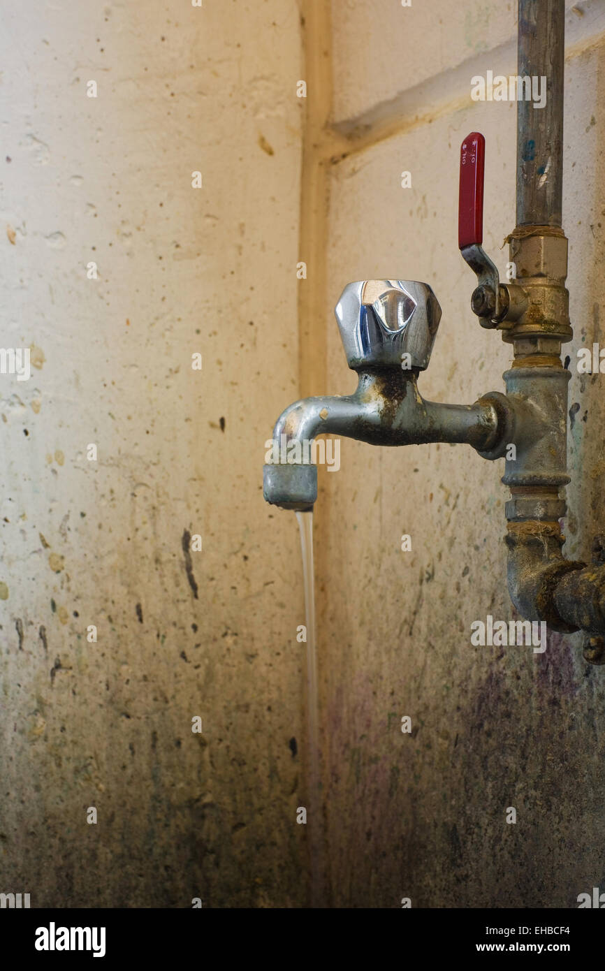 old and dirty faucet with pipes and water Stock Photo Alamy