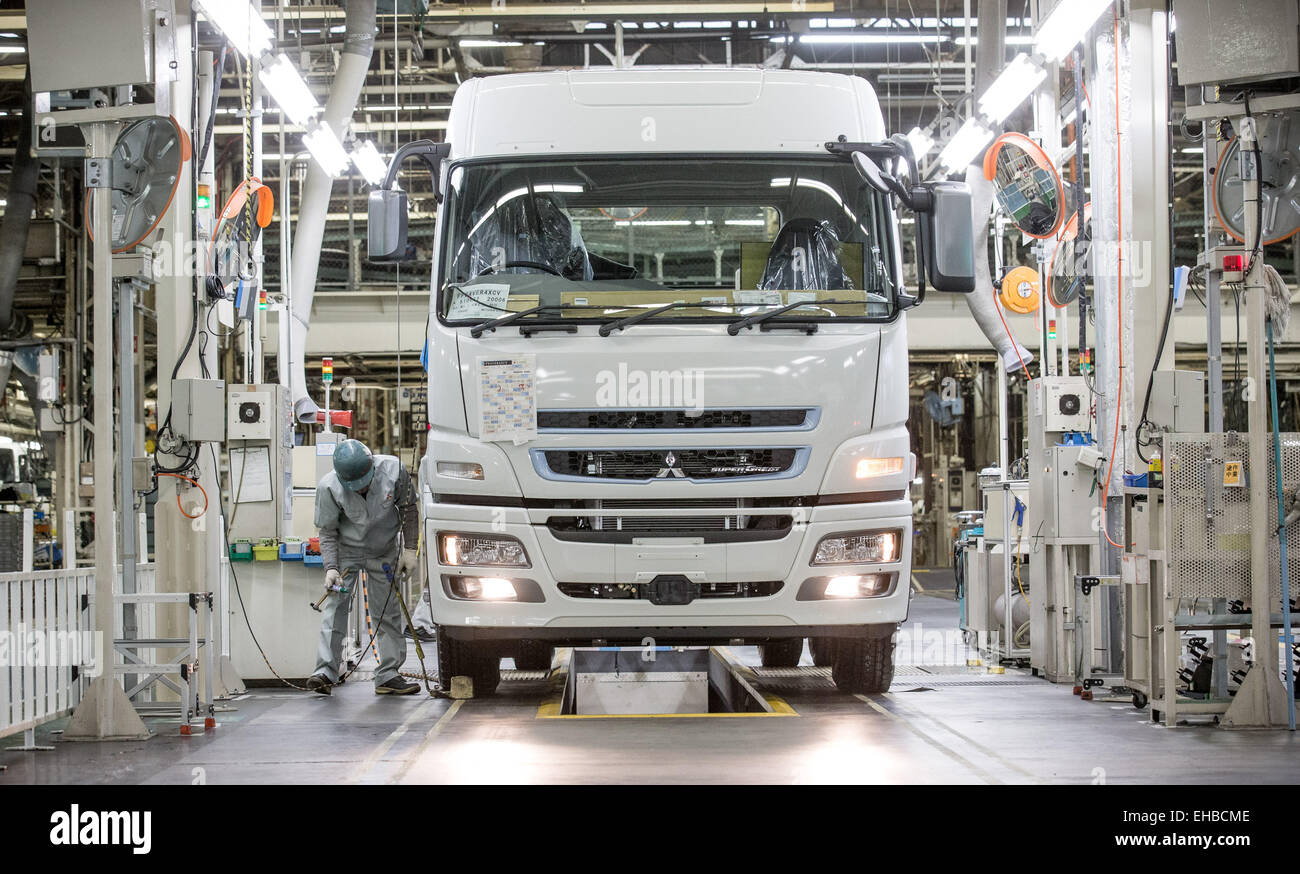 Kawasaki, Japan. 10th Mar, 2015. A staff worker of car manufacturer Mitsubishi Fuso works on a large truck at the Mitsubishi assembly plant in Kawasaki, Japan, 10 March 2015. Photo: Michael Kappeler/dpa/Alamy Live News Stock Photo