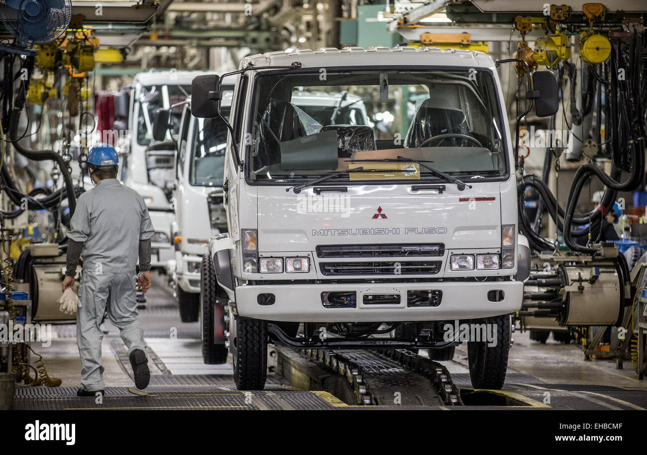 Kawasaki, Japan. 10th Mar, 2015. A staff worker of car manufacturer Mitsubishi Fuso works on a large truck at the Mitsubishi assembly plant in Kawasaki, Japan, 10 March 2015. Photo: Michael Kappeler/dpa/Alamy Live News Stock Photo