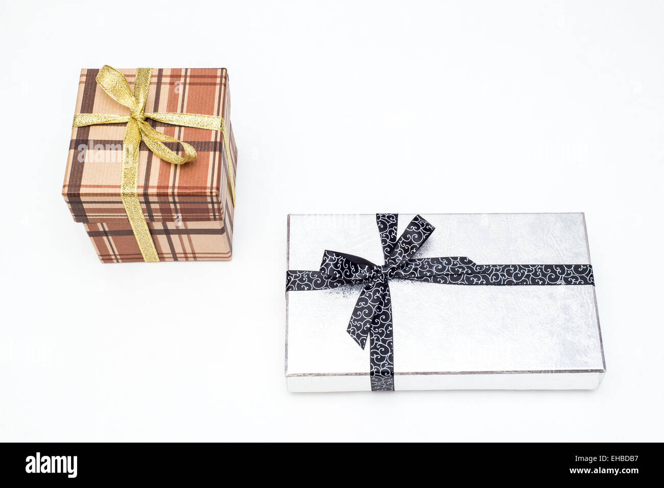 brown and silver gift box with bow on white background Stock Photo - Alamy