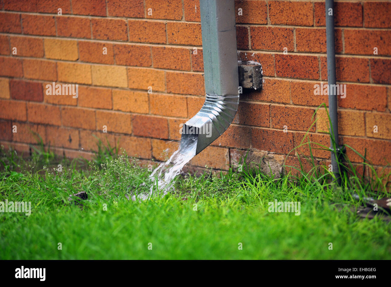 Water runs quickly out of a gutter pipe in South Africa Stock Photo Alamy