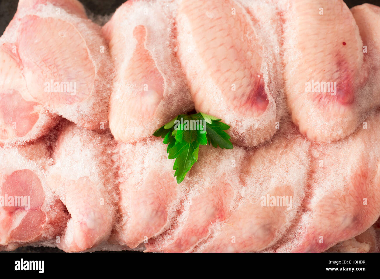 Frozen chicken wings covered with ice Stock Photo Alamy