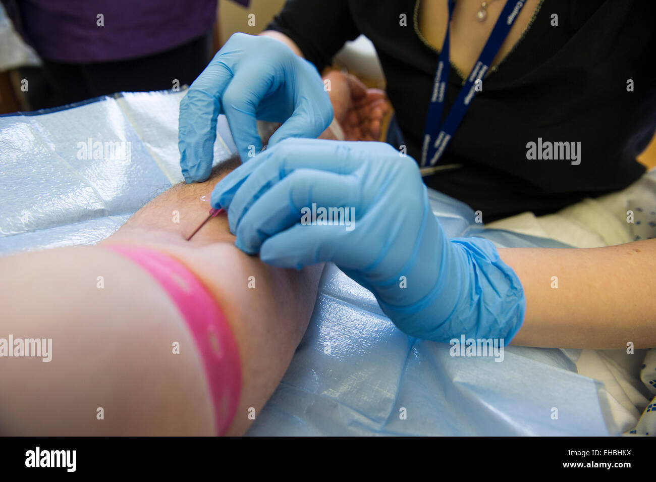 A man has a blood test in a hospital Stock Photo