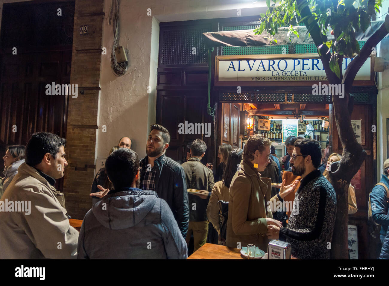 Tapas Restaurant Bar Alvaro Peregil in Seville, Sevilla, Spain with a hipster crowd standing at outside table.Aka La Goleta. Stock Photo