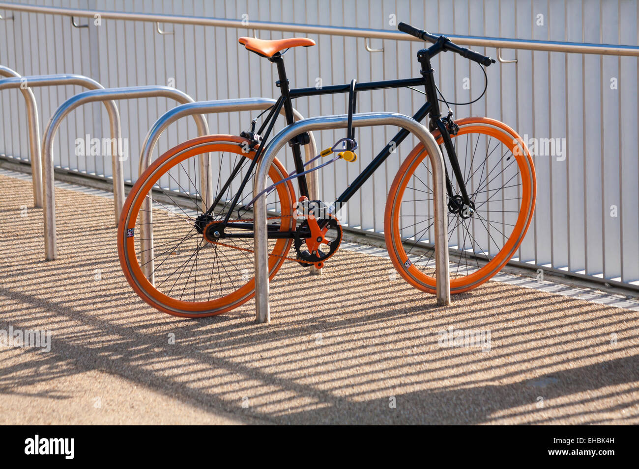 No logo bicycle secured with railings and shadows Stock Photo