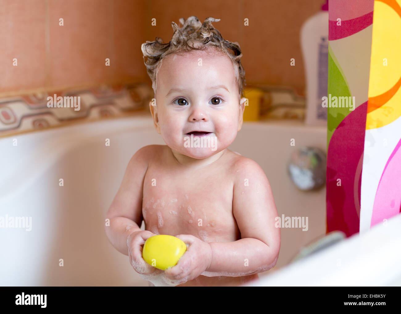 funny baby smiling while taking a bath Stock Photo Alamy