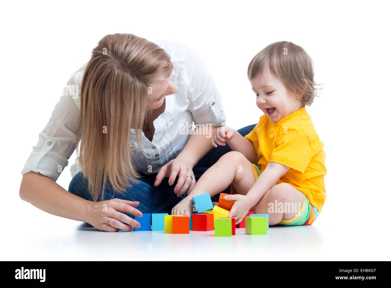 kid boy and mother play together with construction set toy Stock Photo
