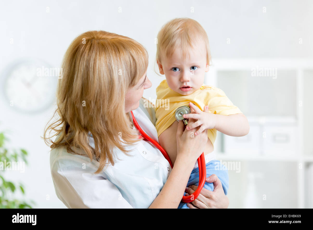 pediatrician examining heartbeat of baby with stethoscope Stock Photo