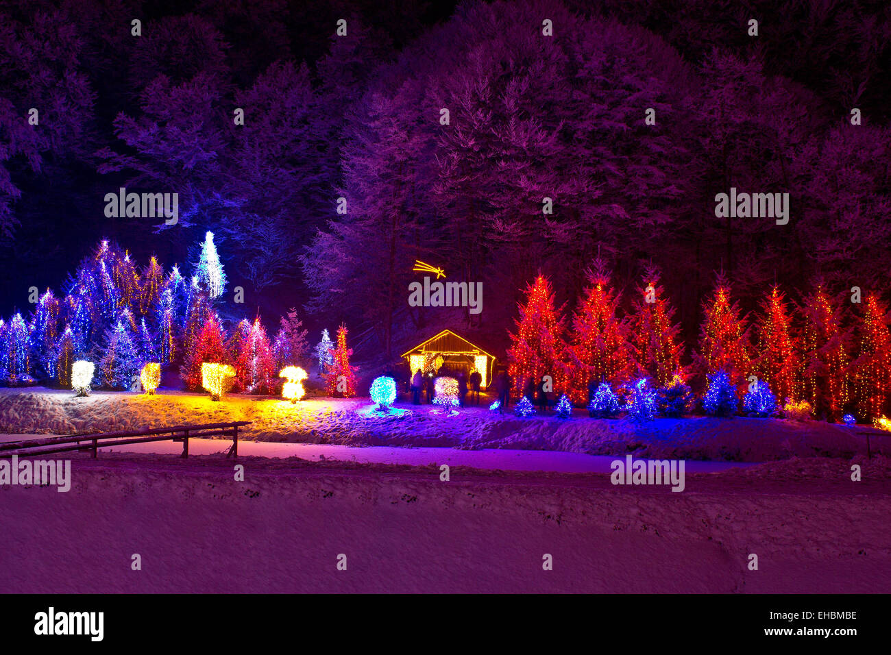 Christmas lights on chapel and trees Stock Photo