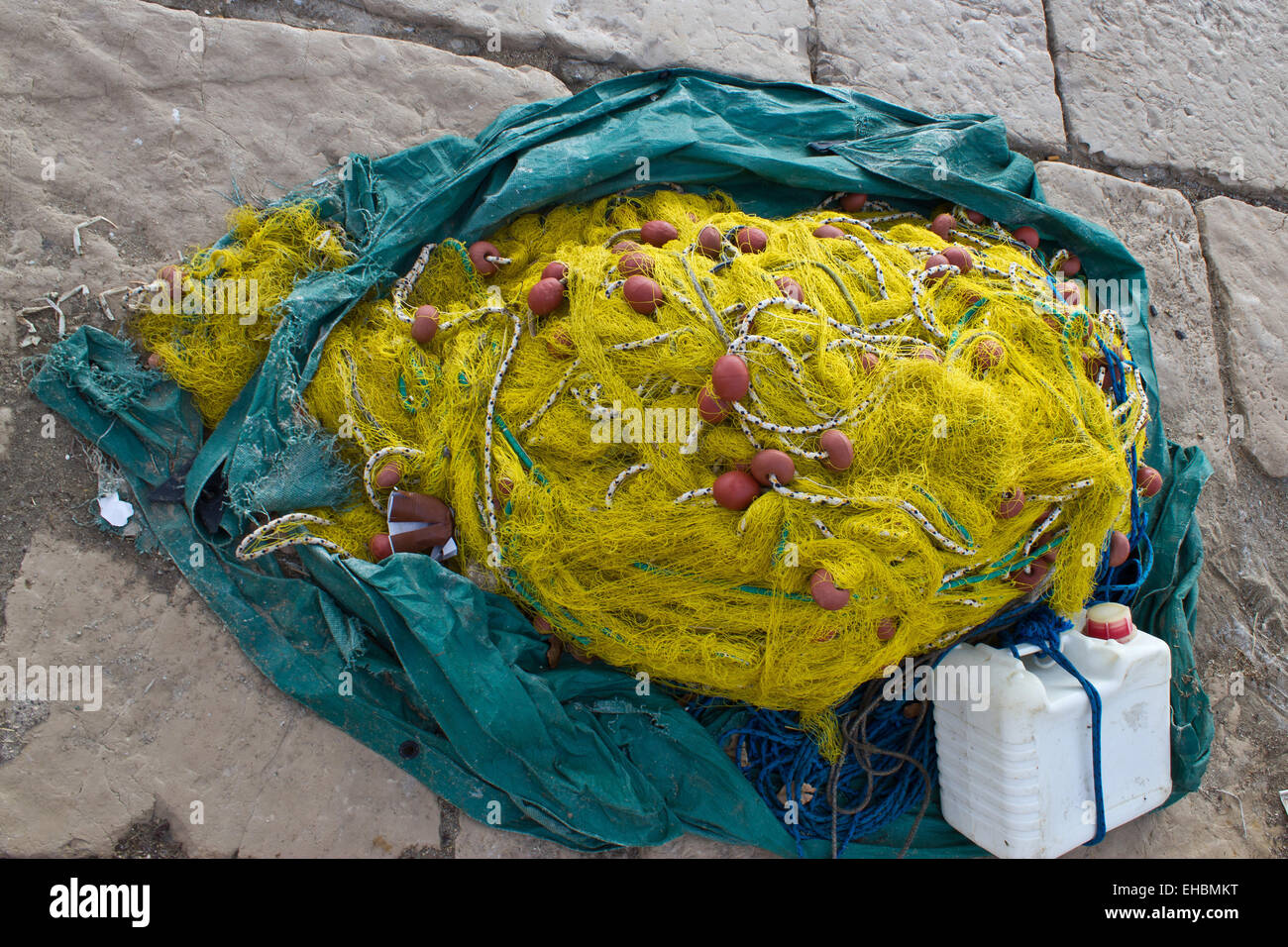 Yellow fishing nets, ropes and canister Stock Photo