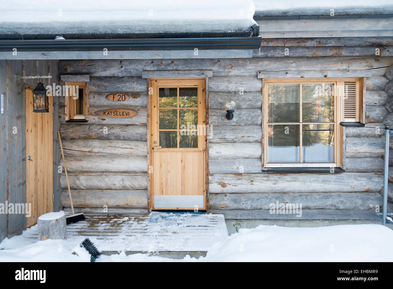 A log cabin  in Levi Lapland Finland with snow and winter sunshine.  Used as winter holiday accommodation. Stock Photo