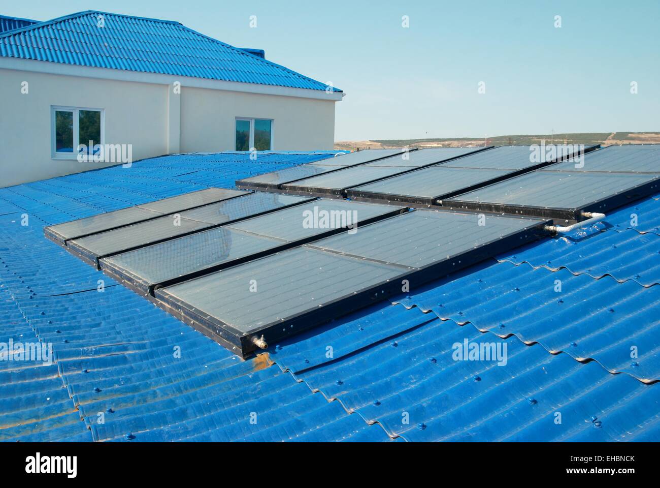 Solar water heating system on the house roof Stock Photo - Alamy