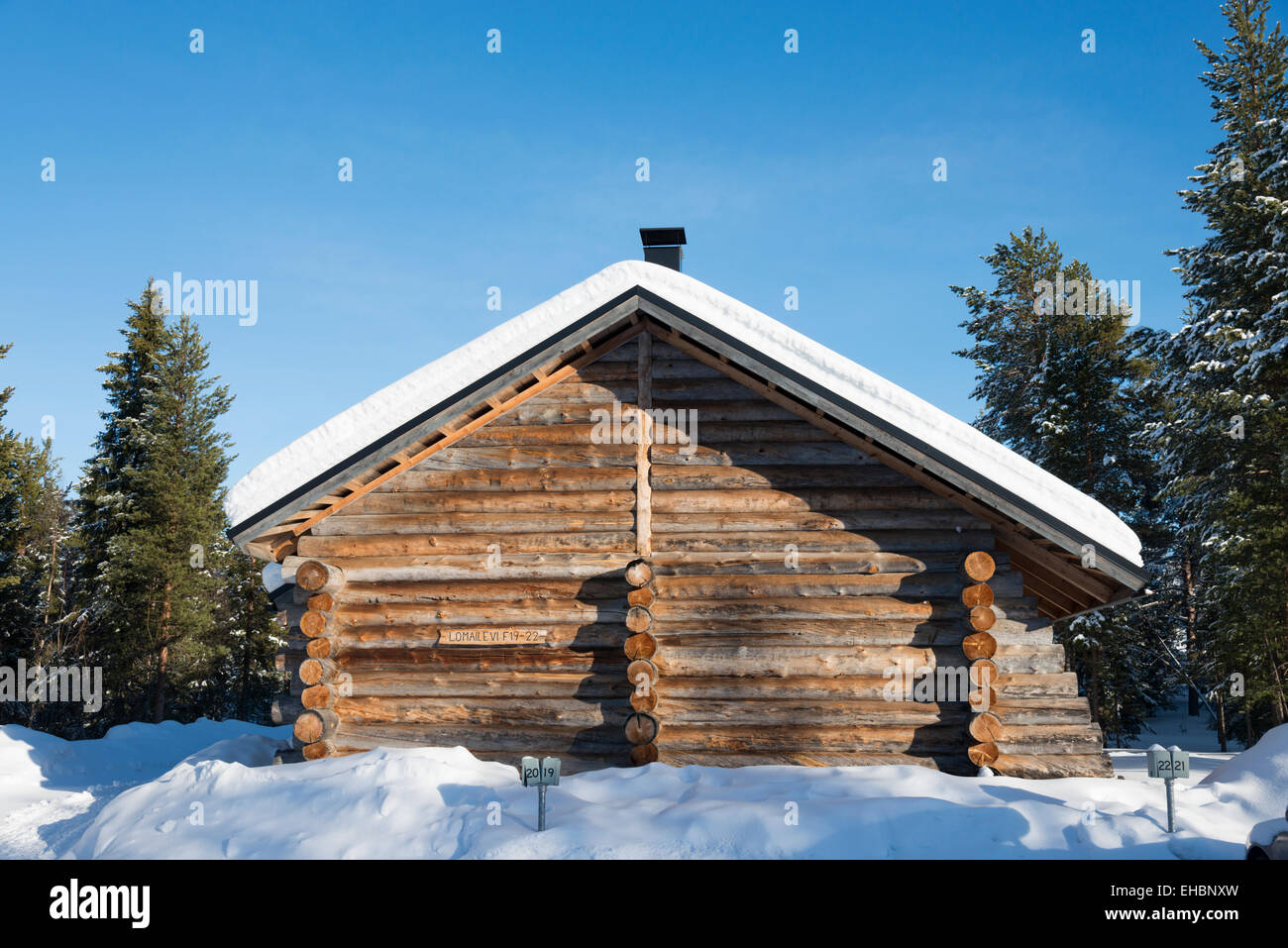 A log cabin in Levi Lapland Finland with snow and winter sunshine. Used as  winter holiday accommodation Stock Photo - Alamy