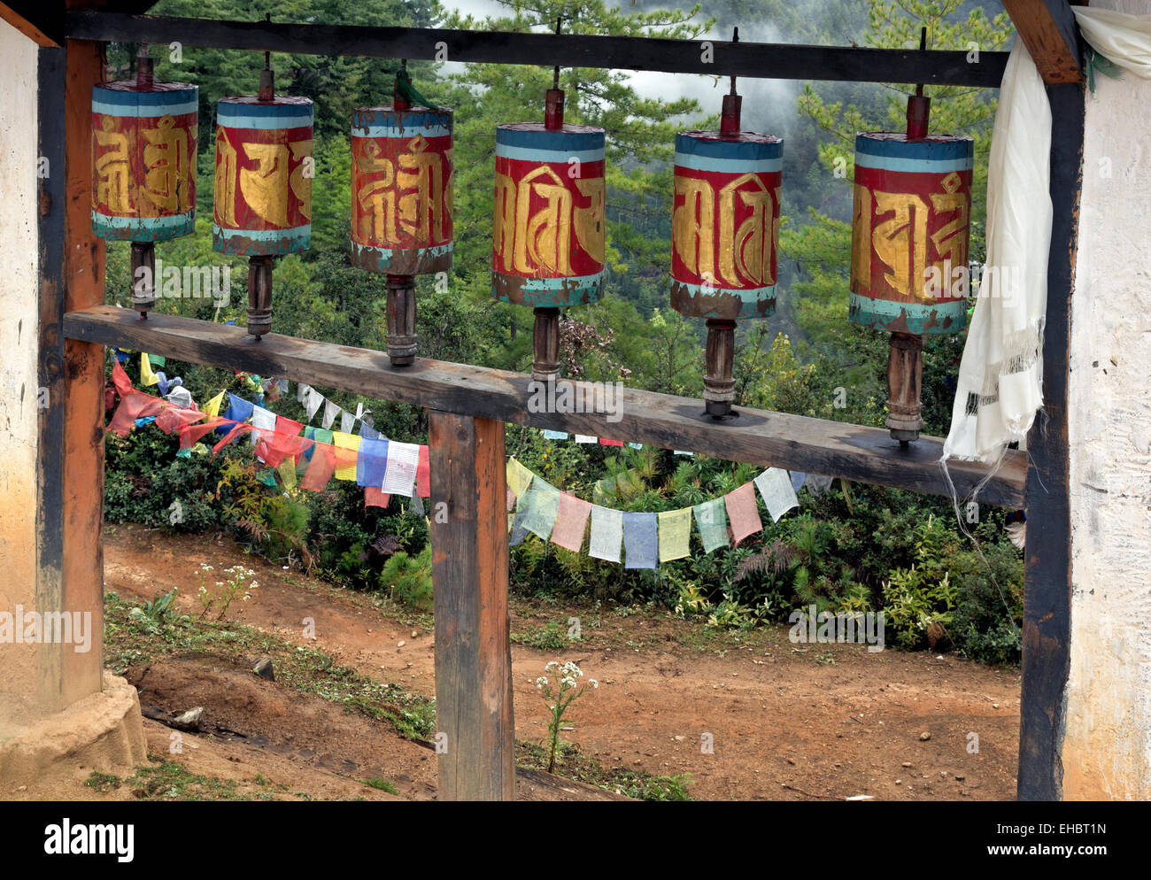 BHUTAN - Prayer wheels and flags along the trail to the Tiger's Nest Monastery located on the side of a cliff. Stock Photo