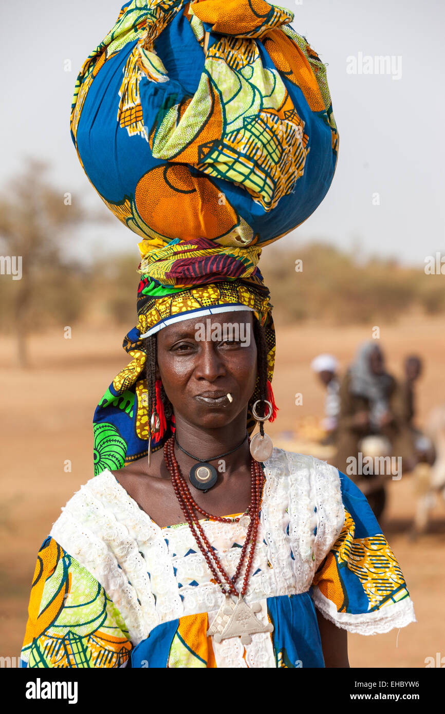 Tera District, west Niger; A woman walking to market carrying her goods for sale on her head. Stock Photo