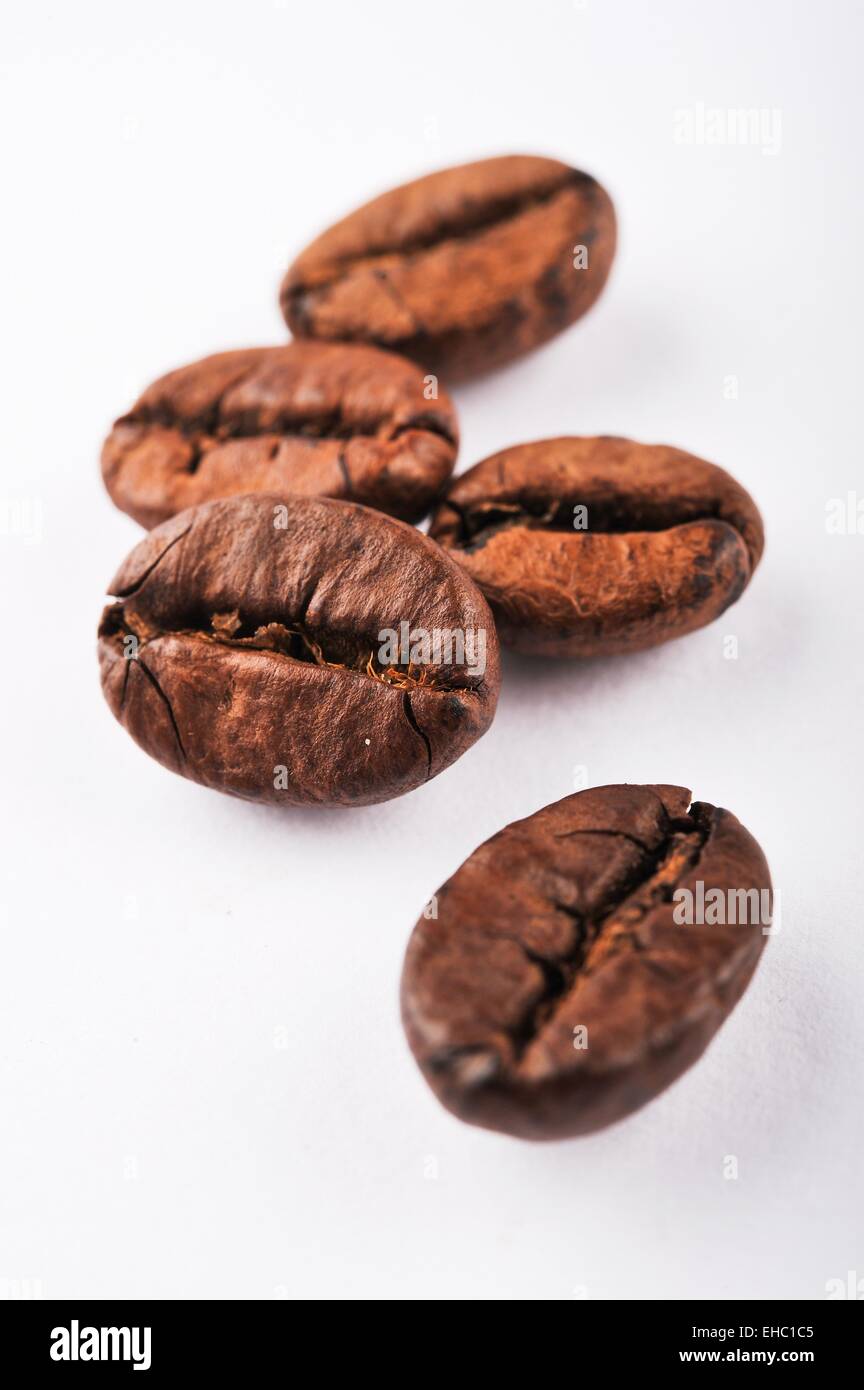 Close-up roasted coffee beans on white background Stock Photo - Alamy