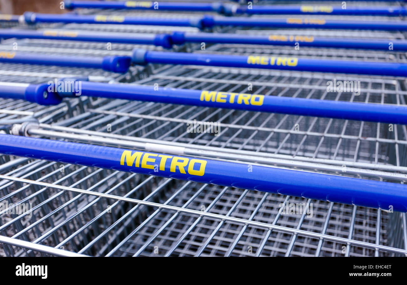Large empty blue shopping cart Metro store. Metro Group is a German