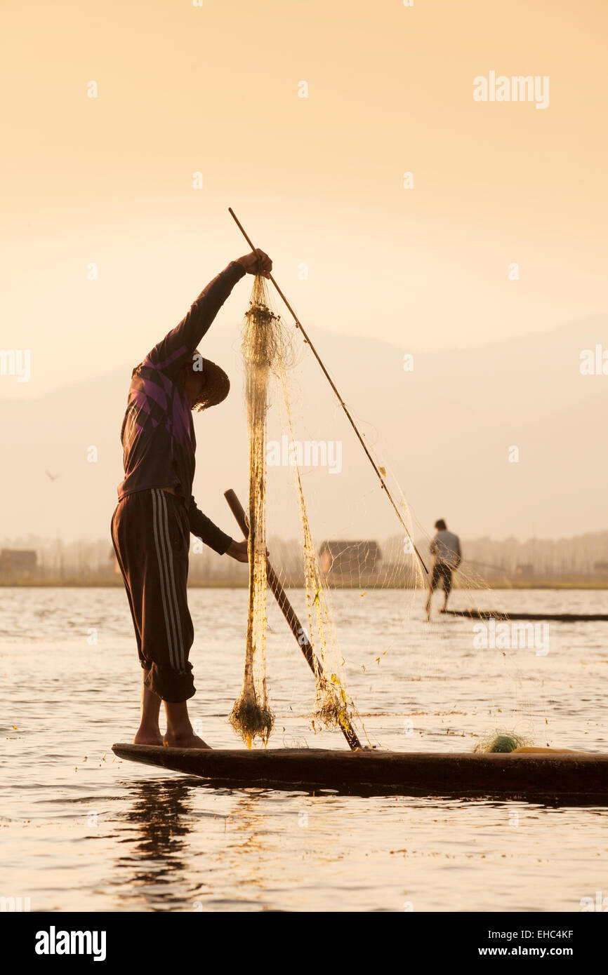 Leg rowing fishermen fishing on Inle Lake at sunrise, Inle lake, Myanmar ( Burma ), Asia Stock Photo