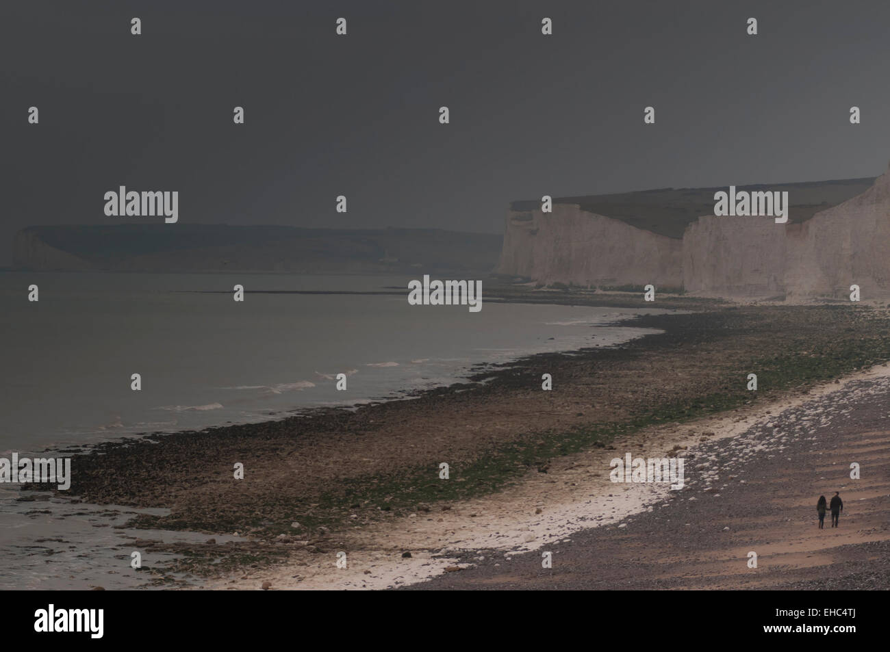 Birling Gap, East Sussex, UK.11 March 2015. Weather: Couple take an evening walk as cloud blocks out the sun and mist rolls in from the sea Stock Photo
