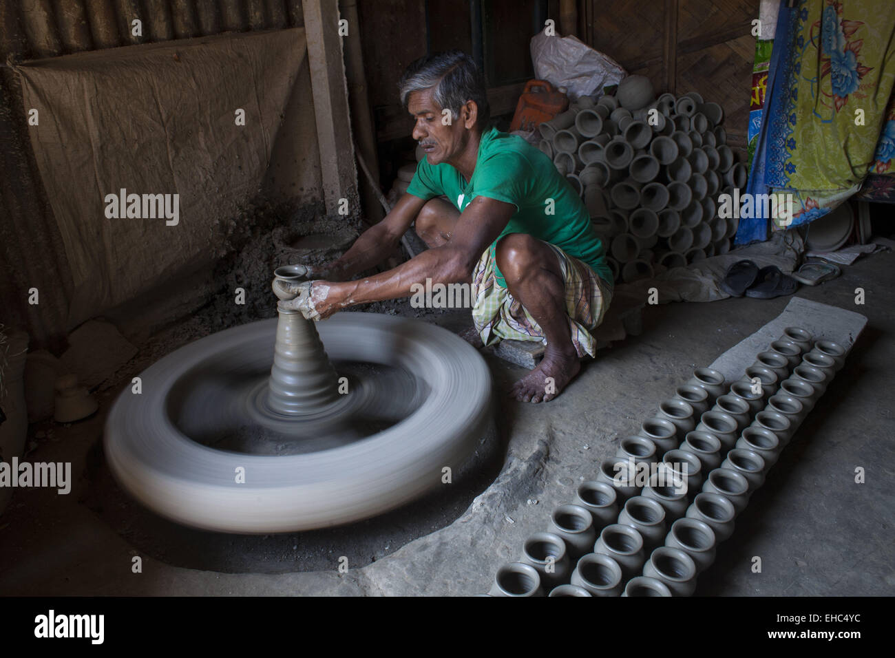 Dhaka, Bangladesh. 11th Mar, 2015.Potter making pots using clay near