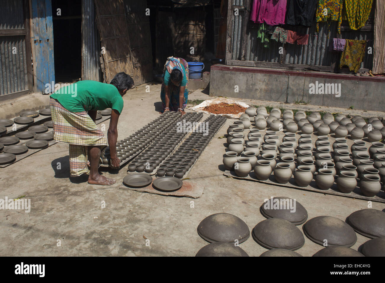 Dhaka, Bangladesh. 11th Mar, 2015.Potter making pots using clay near