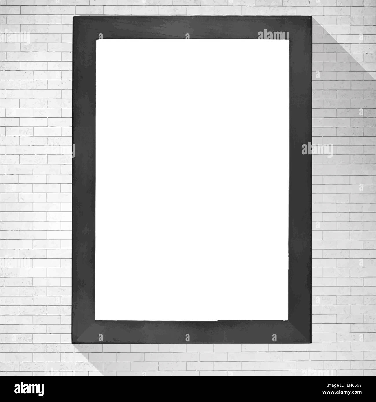 Black wooden frame with white copy space hanging on brick wall. Stock Photo