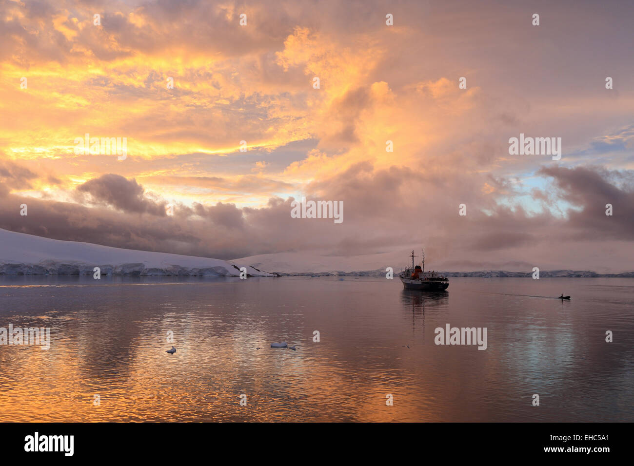 Antarctica landscape sky image of sunset at Port Lockroy. Tourist cruise ship, expedition ship the Ushuaia. Stock Photo