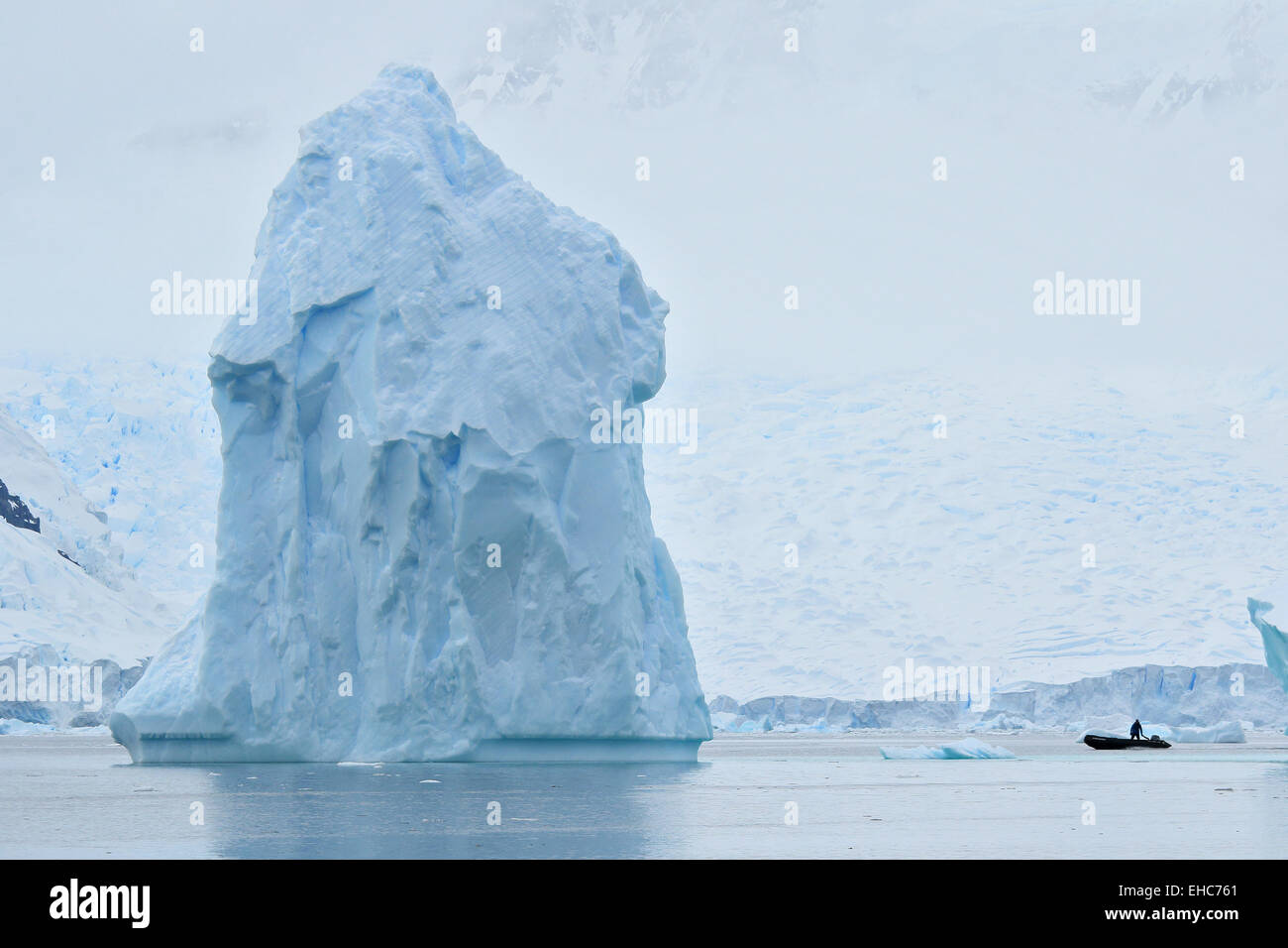 Antarctica iceberg, ice berg, floats in Antarctica landscape of ice with Zodiac driver. Stock Photo